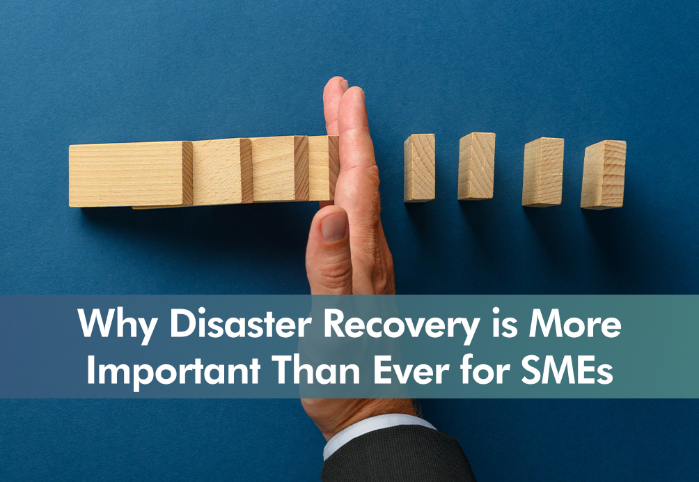 hand knocking over wooden dominoes with insight title 'Why Disaster Recovery is More Important Than Ever for SMEs '