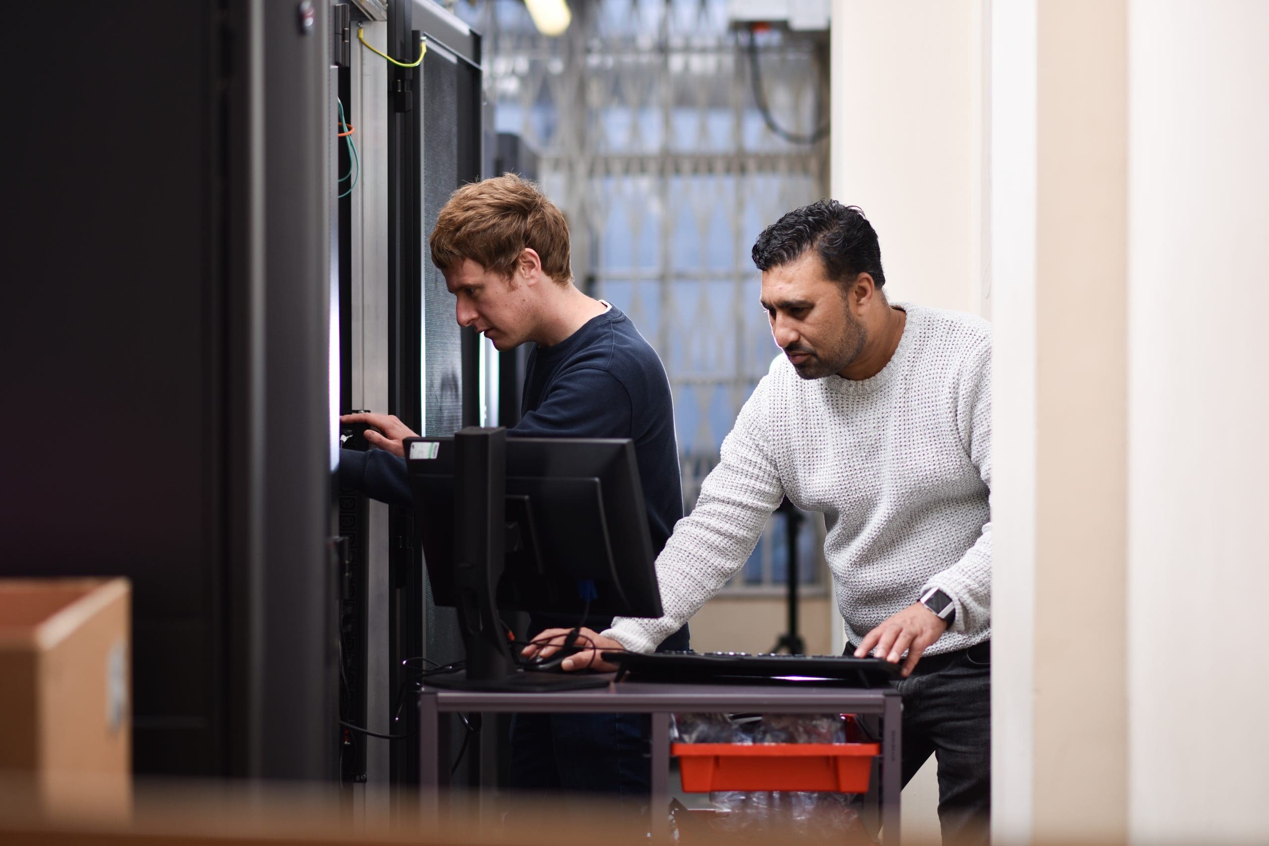Two Cantium employees working in the data centre on server maintenance.
